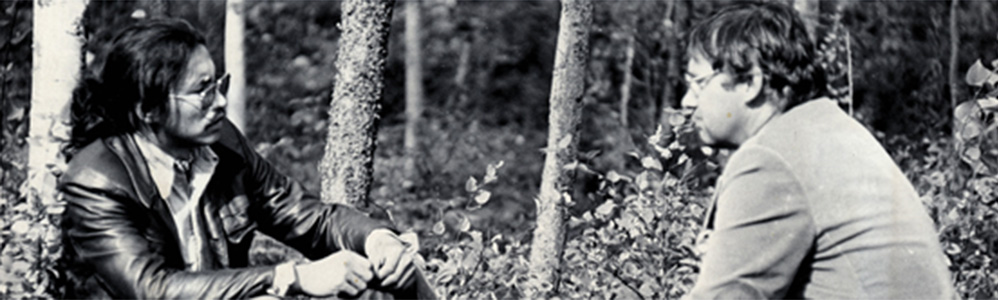 Jim talking with Justice Berger in a forest