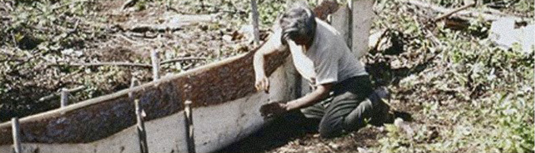 Johnny making a bark canoe